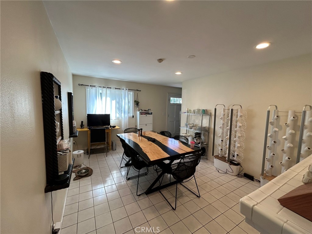 2305 Rockefeller Lane, Unit A Redondo Beach, CA 90278 - Photo 43 of 53 a living room with furniture a flat screen tv and white walls