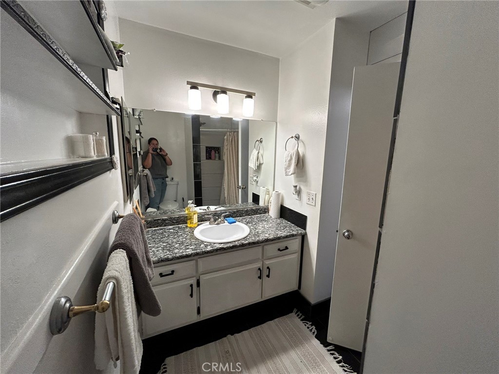 2305 Rockefeller Lane, Unit A Redondo Beach, CA 90278 - Photo 48 of 53 a en suite bathroom with a granite countertop sink a mirror and shower