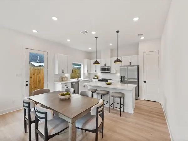 a kitchen with a table and chairs in it