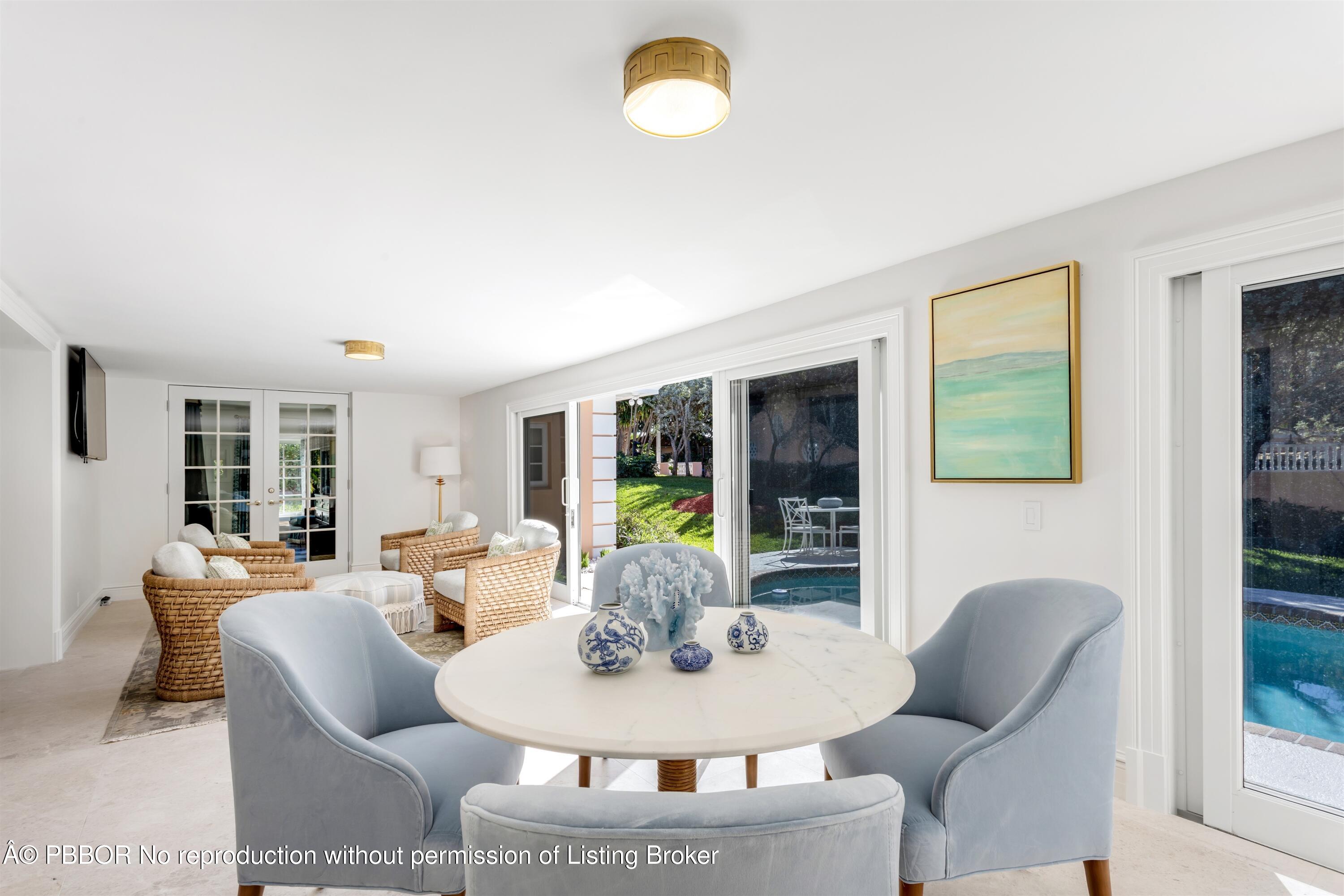 124 Woodbridge Road Palm Beach, FL 33480 - Photo 19 of 44 a living room with furniture potted plant and a large window
