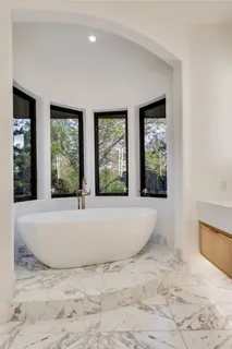 a view of an empty room with large windows