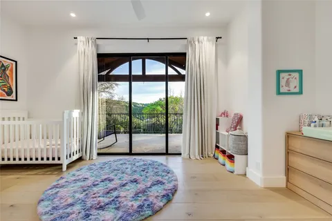 a bedroom with a bed and a large window