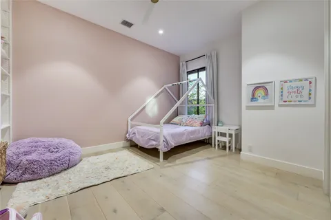a spacious bedroom with a bed and a window