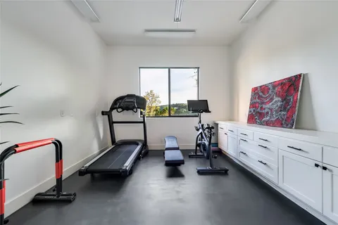 a room with gym equipment and a window