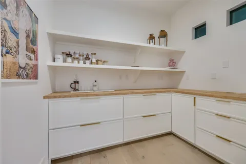 a kitchen with cabinets and a wooden floor