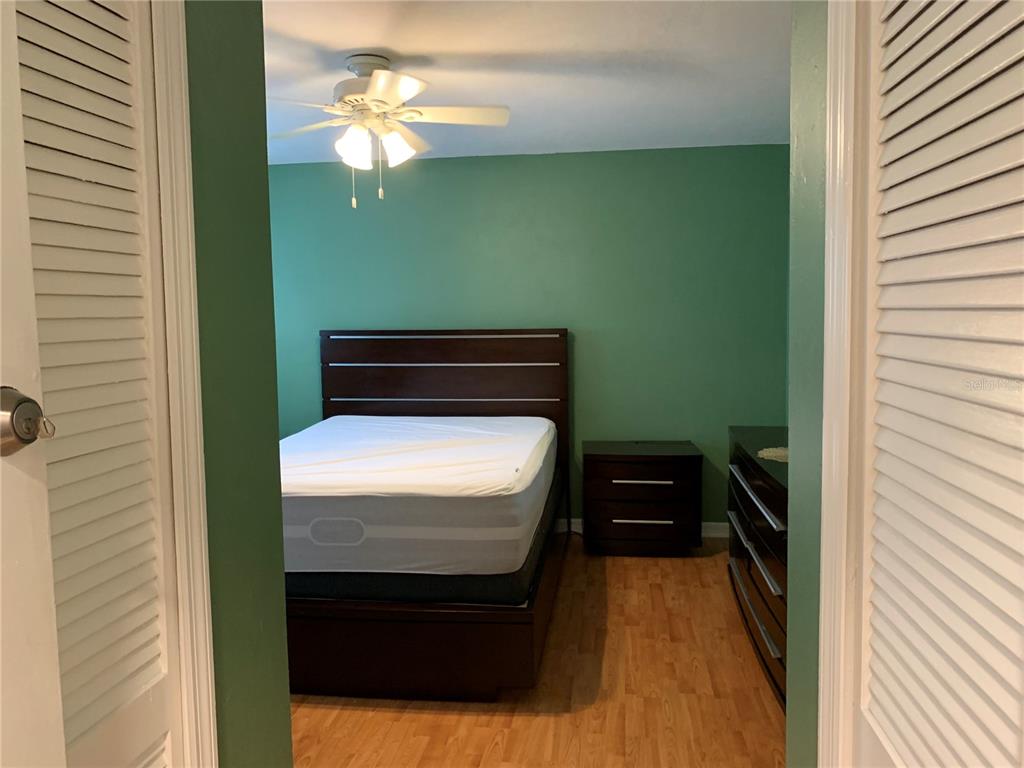 5754 Southwest 8th Place Gainesville, FL 32607 - Photo 17 of 29 a bedroom with a bed and a chandelier