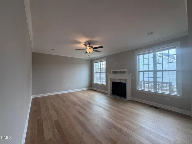 a large kitchen with a large counter top a sink stainless steel appliances and cabinets