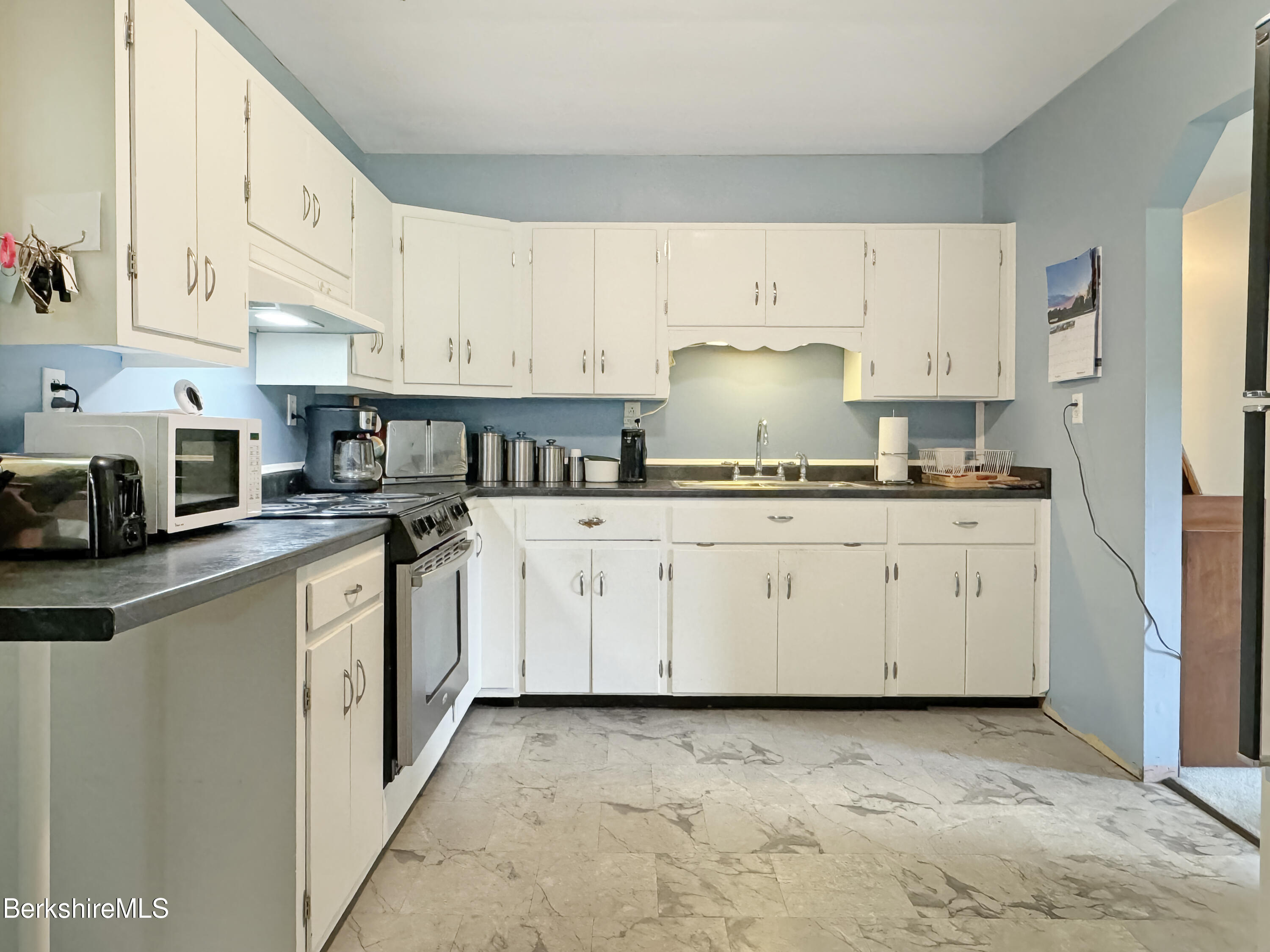 27 Swamp Road West Stockbridge, MA 01266 - Photo 17 of 45 a kitchen with white cabinets and white appliances