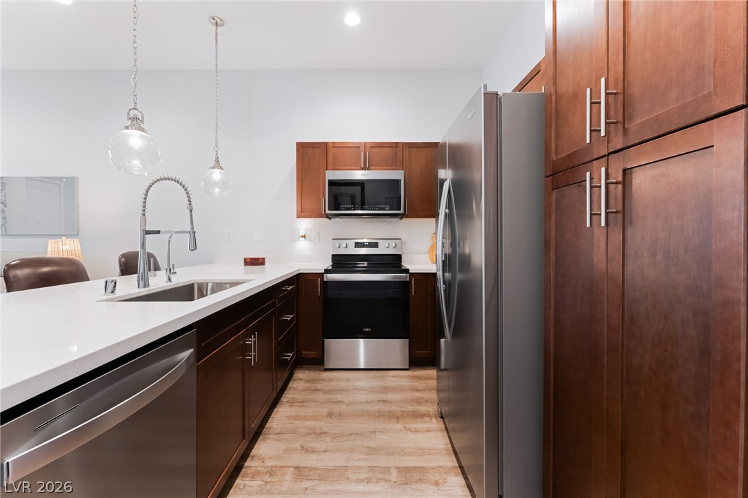 6432 Spring Jog Street Las Vegas, NV 89166 - Photo 12 of 61 Culinary delights await in this modern kitchen with pristine countertops and stainless steel appliances.