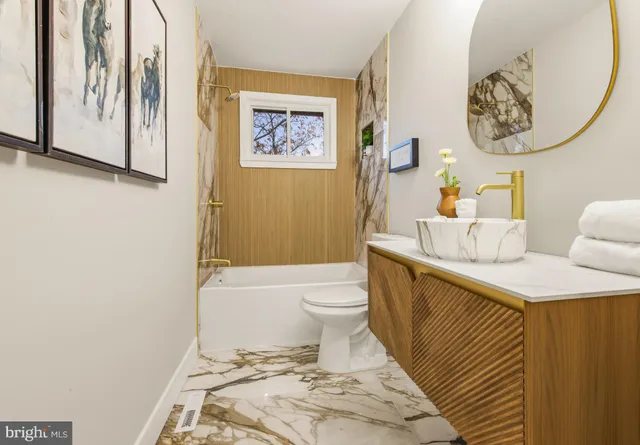 a bathroom with a toilet a sink and bathtub