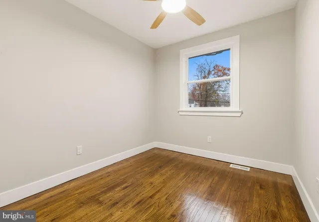 a view of a room with wooden floor and window