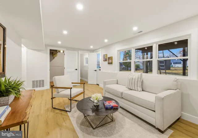 a living room with furniture and a book shelf
