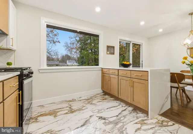 a view of a kitchen with wooden floor and electronic appliances