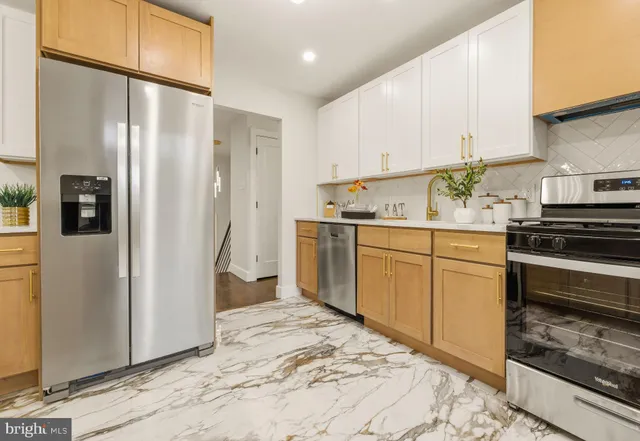 a kitchen with stainless steel appliances a refrigerator sink and cabinets
