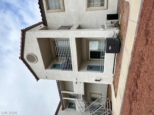 3318 North Decatur Boulevard, Unit 1069 Las Vegas, NV 89130 - Photo 33 of 39 A multi-story building exterior showcases stucco siding and private balconies, offering comfortable living spaces.