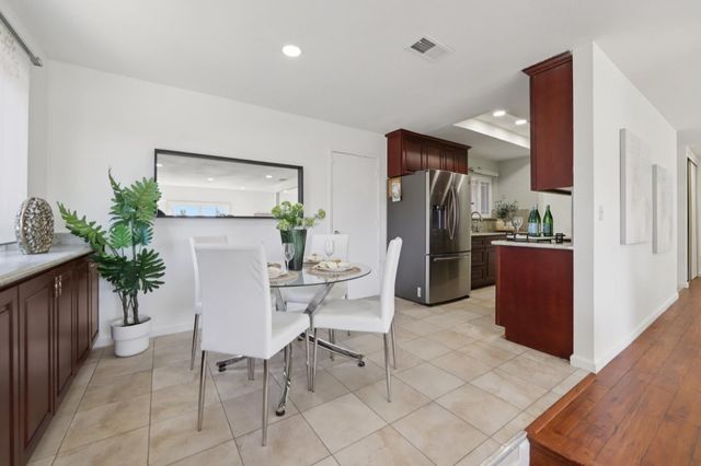 a living room with furniture a potted plant and a table