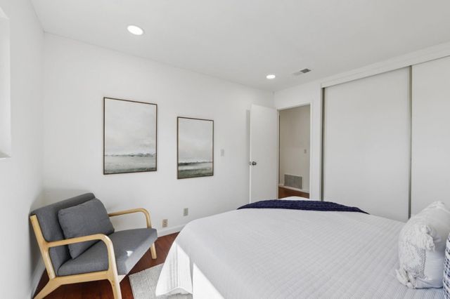 a bedroom with a bed and a couch