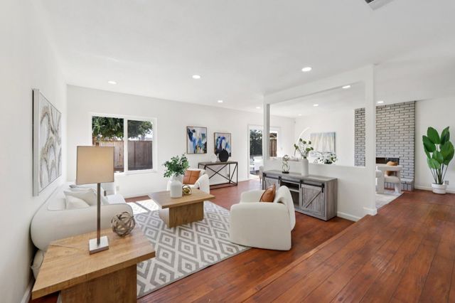 a living room with fireplace furniture and a wooden floor