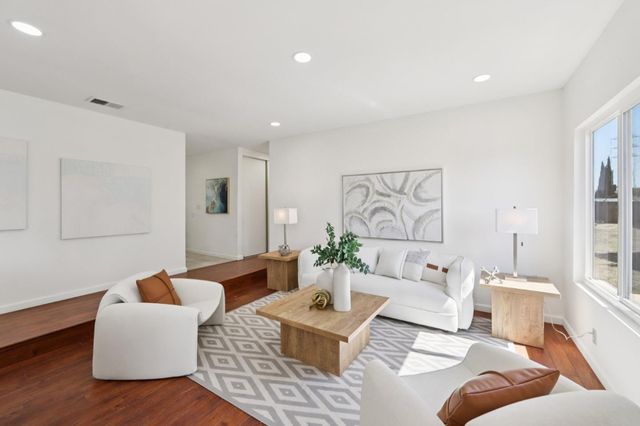 a living room with furniture or couch and a large window