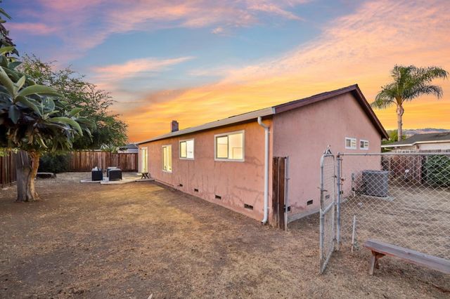 a view of a house with a yard and garage
