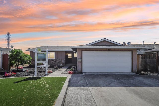 a backyard of a house with table and chairs