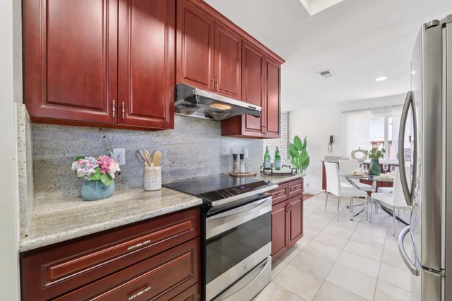 a kitchen with sink cabinets and appliances