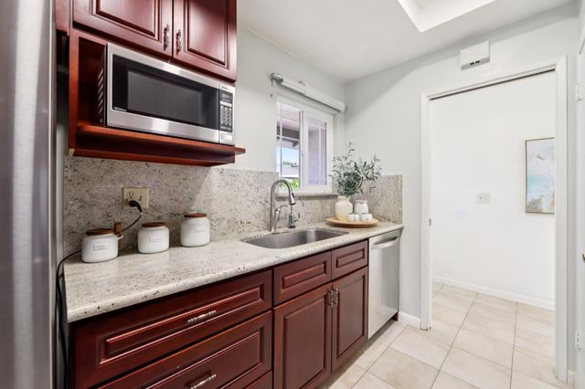 a kitchen with granite countertop stainless steel appliances and cabinets