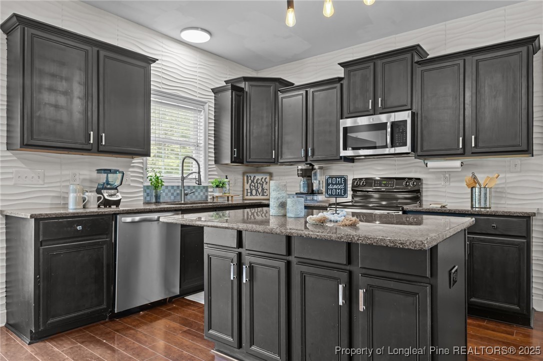 315 St Johns Loop Raeford, NC 28376 - Photo 13 of 47 a kitchen with kitchen island granite countertop wooden cabinets and a sink