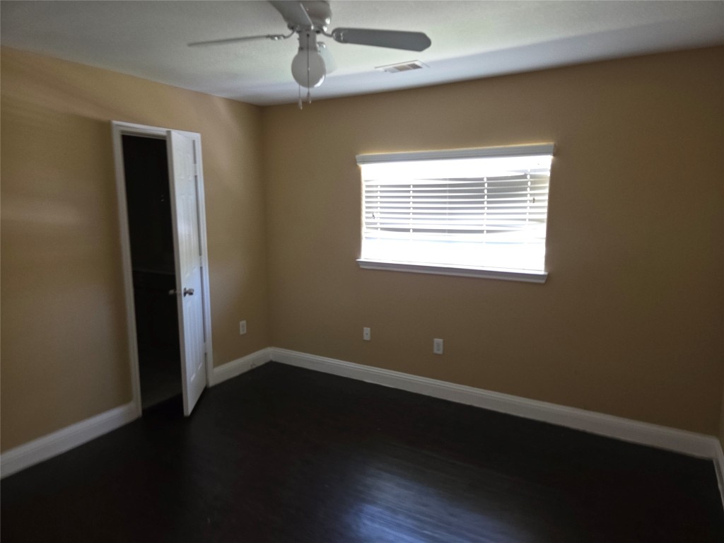 7709 Rhobell Street, Unit B Houston, TX 77016 - Photo 19 of 21 a view of an empty room with wooden floor and a window