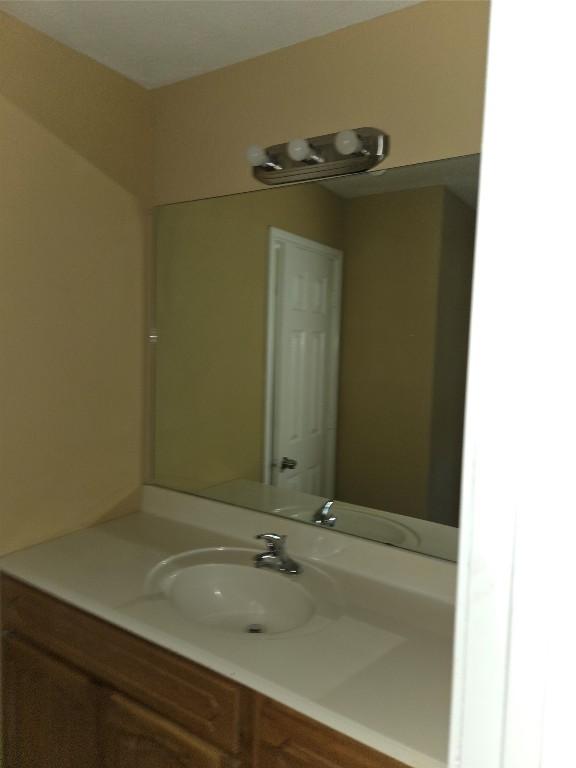 7709 Rhobell Street, Unit B Houston, TX 77016 - Photo 21 of 21 a bathroom with a sink and a mirror