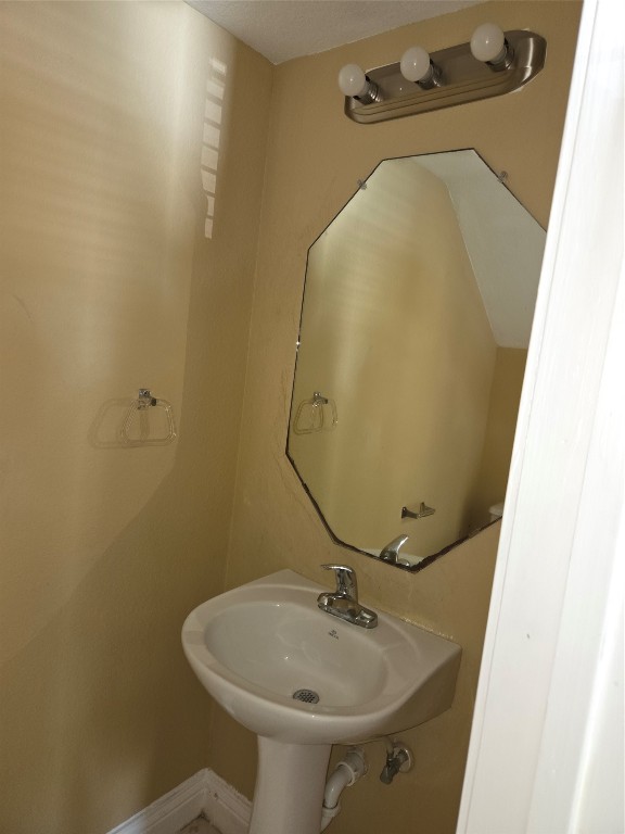 7709 Rhobell Street, Unit B Houston, TX 77016 - Photo 7 of 21 a bathroom with a sink and mirror