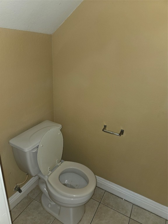 7709 Rhobell Street, Unit B Houston, TX 77016 - Photo 8 of 21 a white toilet sitting next to a white sink and vanity