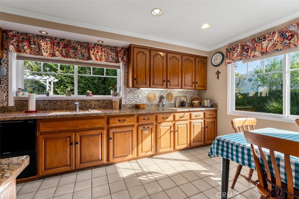 19512 Sierra Mia Road Irvine, CA 92603 - Photo 15 of 46 a kitchen with a sink window and cabinets