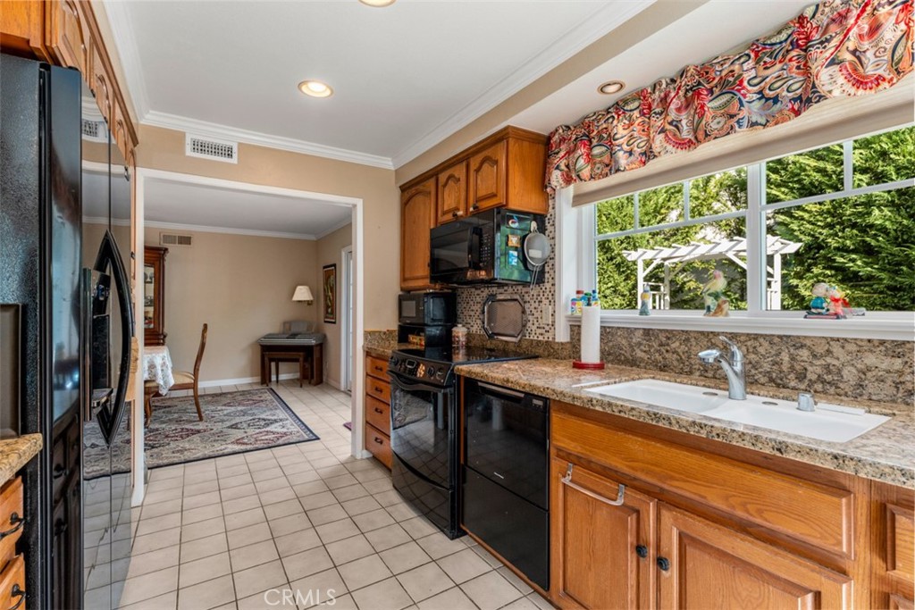 19512 Sierra Mia Road Irvine, CA 92603 - Photo 16 of 46 a kitchen with stainless steel appliances granite countertop a sink and a counter space