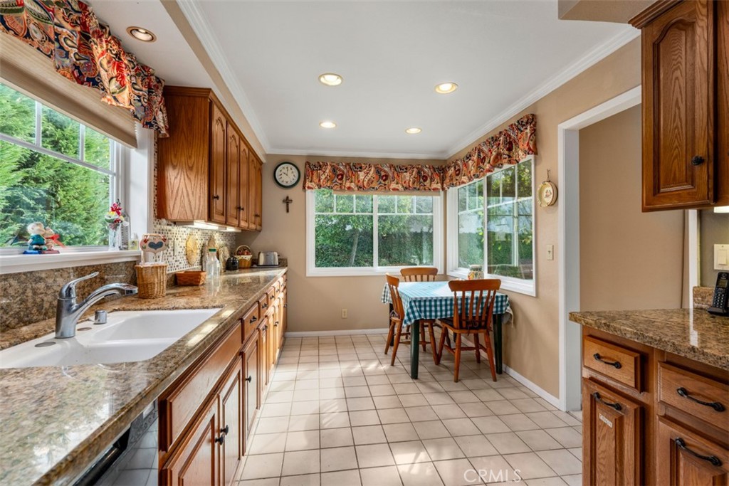 19512 Sierra Mia Road Irvine, CA 92603 - Photo 17 of 46 a kitchen with granite countertop a sink and a stove