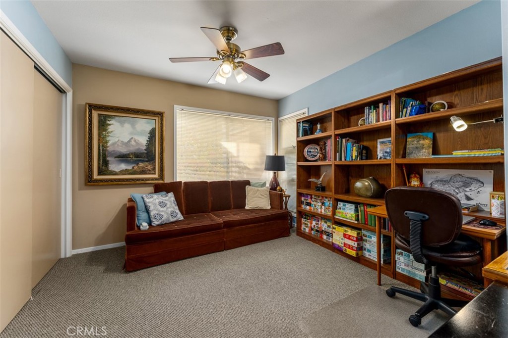 19512 Sierra Mia Road Irvine, CA 92603 - Photo 27 of 46 a living room with furniture and a bookshelf