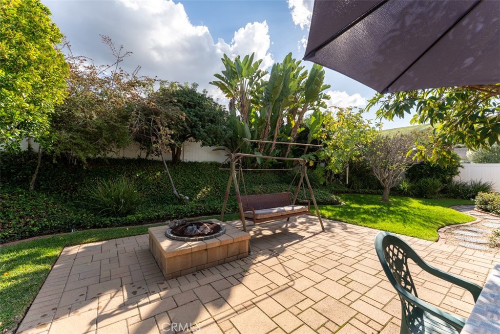 19512 Sierra Mia Road Irvine, CA 92603 - Photo 37 of 46 a view of a backyard with table and chairs potted plants and large tree