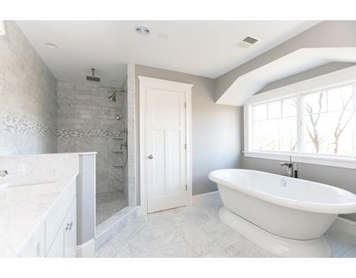 100 Elmwood Road Wellesley, MA 02481 - Photo 23 of 27 a bathroom with a white tub a sink and a large mirror