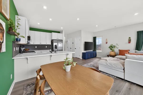 a kitchen with stainless steel appliances granite countertop a cabinets and a table