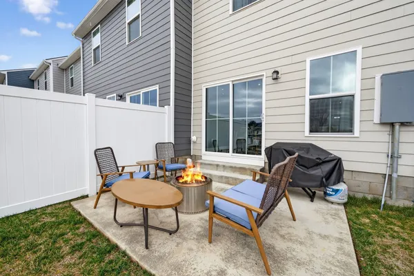 a view of a house with backyard and sitting area