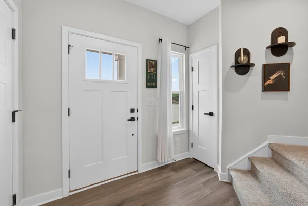 a view of entryway and hall with wooden floor