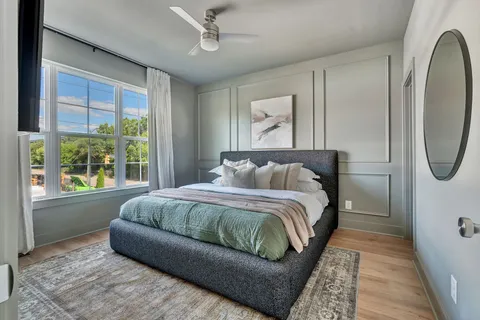 a living room with a bed couch and a window