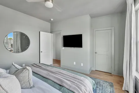 a bedroom with a bed and a mirror