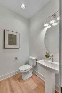 a bathroom with a toilet a sink and mirror
