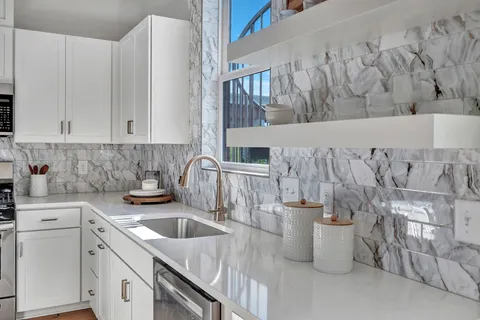 a kitchen with a sink and a stove top oven