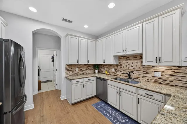 a kitchen with a sink stove and cabinets