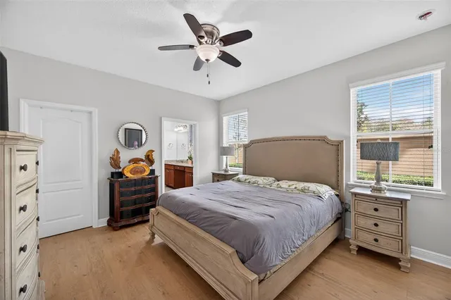 a bathroom with a granite countertop double vanity sink and a mirror