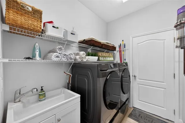 a living room with furniture potted plant and a large window
