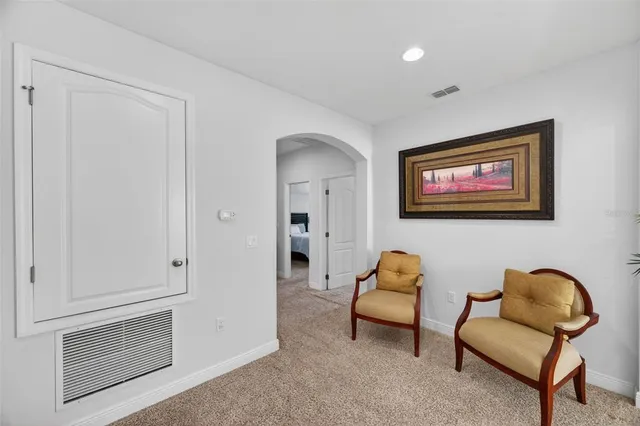 a bathroom with a granite countertop double vanity and a mirror