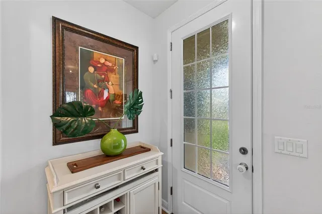 a living room with furniture a flat screen tv and a window